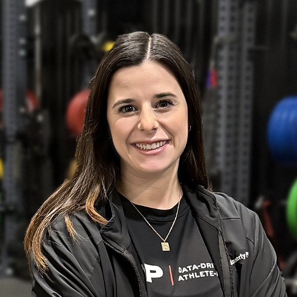 Abbie Minnerly, iTOP Physical Therapist, smiling with arms crossed in the Lubbock gym