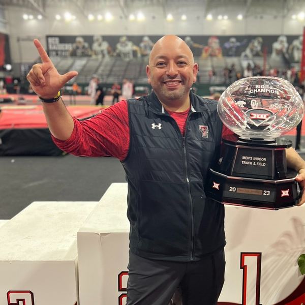 Frank Perez, iTOP Owner and Director, holding a championship trophy