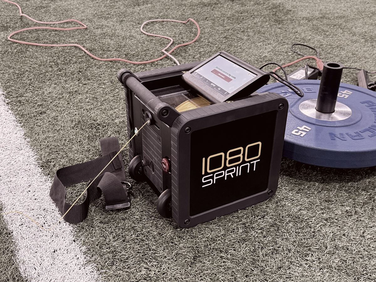 1080 Sprint unit with its touchscreen and harness on turf at an iTOP facility