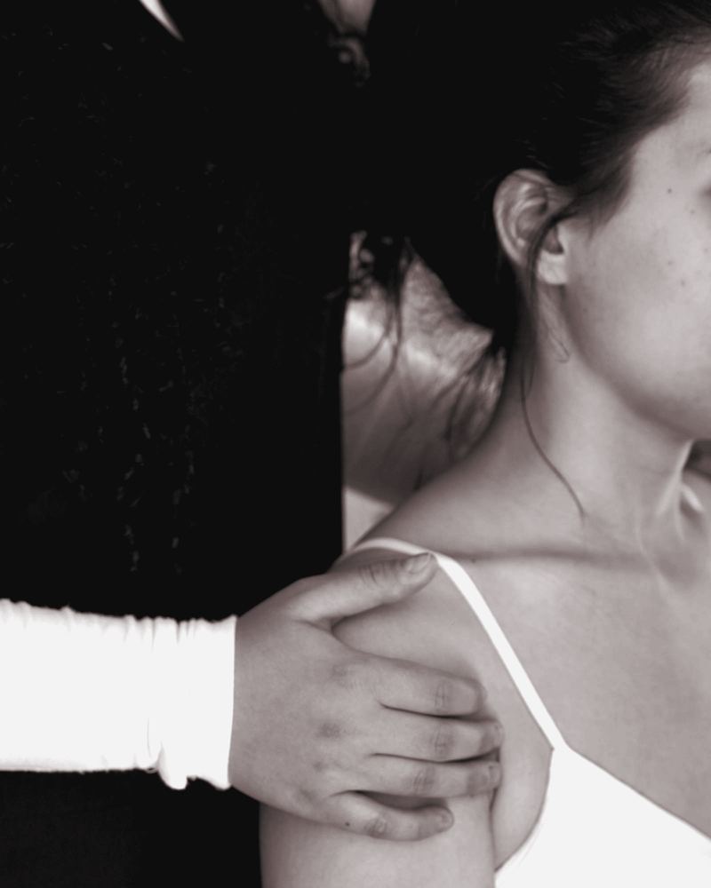 Clinician assessing an adult woman's shoulder
